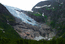 Норвегия.  Ледник  Юстедалсбреен и снежники с водопадами